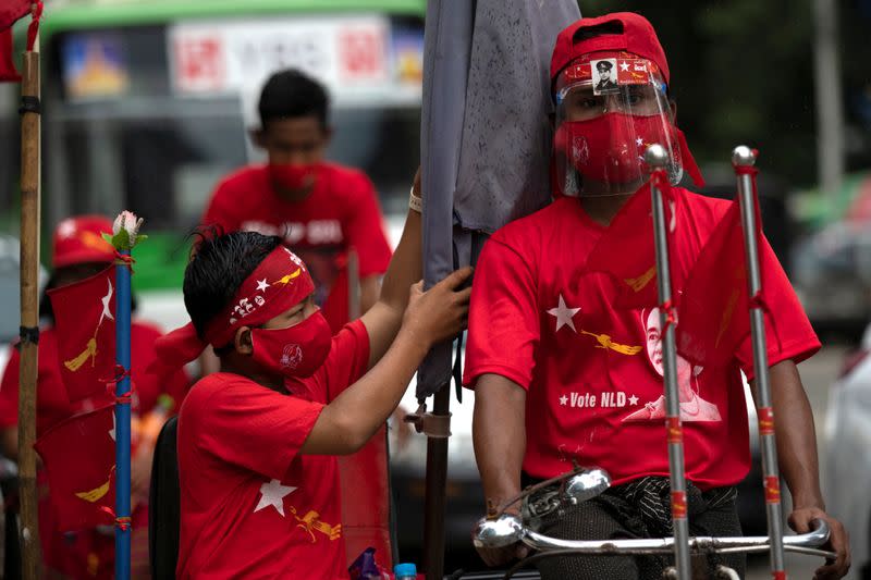 NLD supporters wearing face masks take part in an election campaign rallly amid the coronavirus disease (COVID-19) spread in Yangon