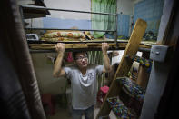 Gou Weiming, who works in a local printing company, can hardly stand up straight under his bed (Rex)