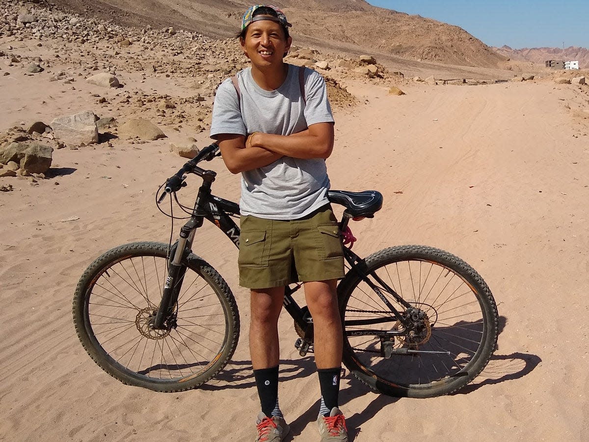 Tino Roco in front of his bike in the desert