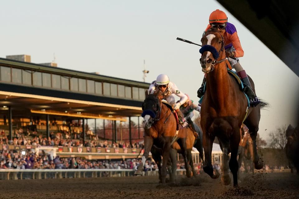 John Velazquez, right, rides Authentic to win the Breeder's Cup Classic horse race at Keeneland Race Course, in Lexington, Ky., Saturday, Nov. 7, 2020. (AP Photo/Darron Cummings)