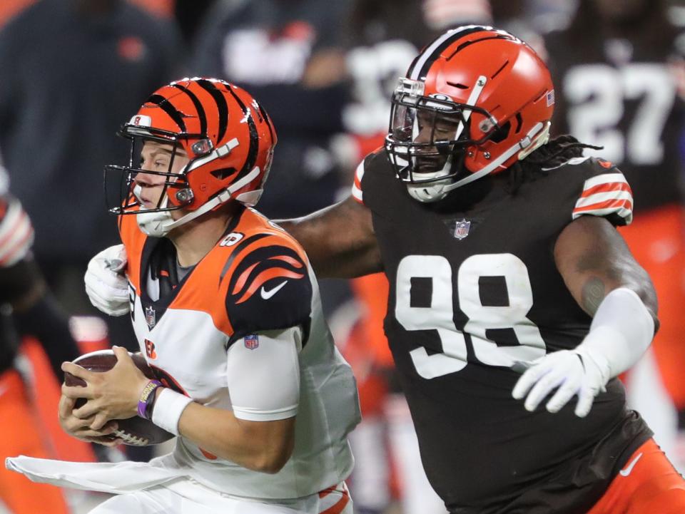 Cleveland Browns defensive tackle Sheldon Richardson (98) sacks Cincinnati Bengals quarterback Joe Burrow (9) during the first half of an NFL football game at FirstEnergy Stadium, Thursday, Sept. 17, 2020, in Cleveland, Ohio. [Jeff Lange/Beacon Journal]