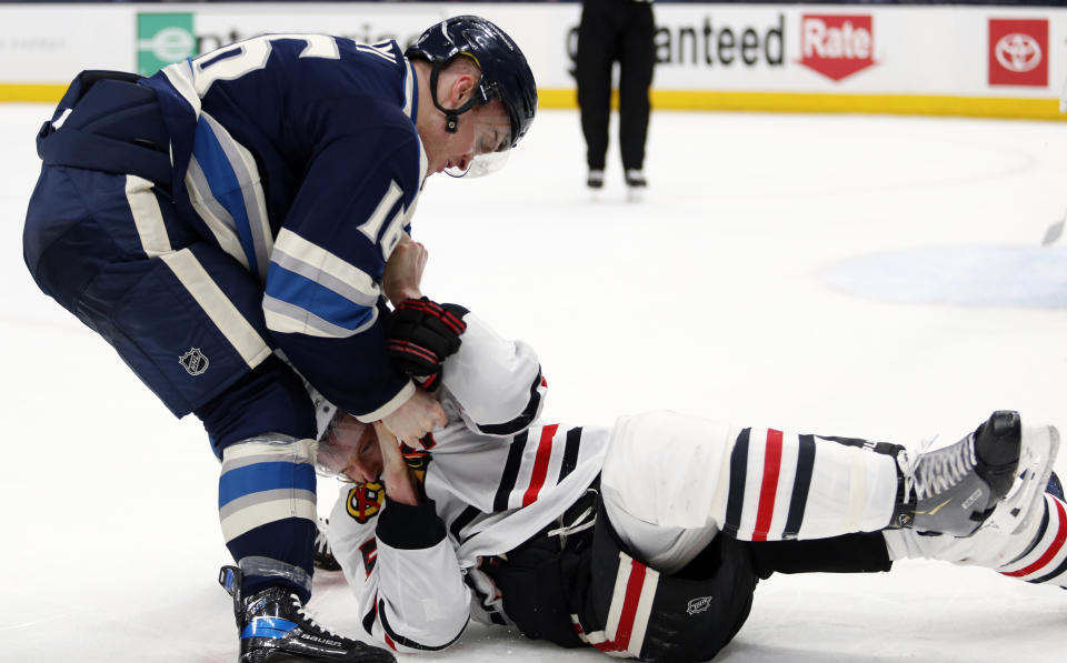 Columbus Blue Jackets forward Max Domi, left, fights with Chicago Blackhawks defenseman Connor Murphy during the second period of an NHL hockey game in Columbus, Ohio, Monday, April 12, 2021. (AP Photo/Paul Vernon)