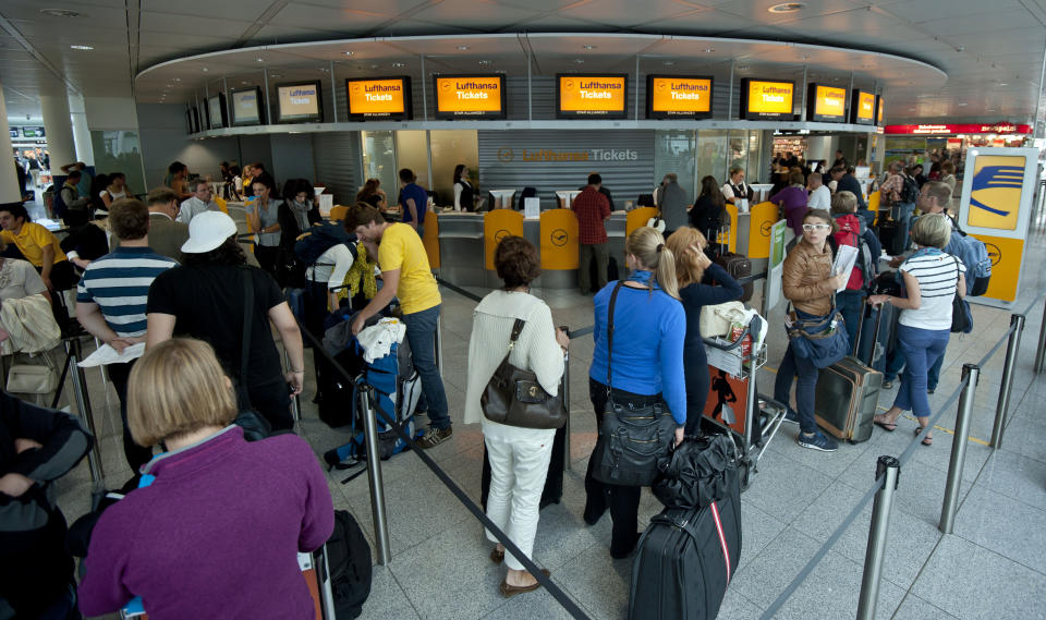Passengers line up at Lufthansa counters at the airport in Munich, southern Germany, Tuesday, Sept. 4, 2012, during a strike of Lufthansa flight attendants. UFO, the union for the cabin crews, is seeking a 5 percent pay raise for the airline's more than 18,000 cabin crew workers. Lufthansa has said it is offering a 3.5 percent raise. (AP Photo/dapd, Lukas Barth)