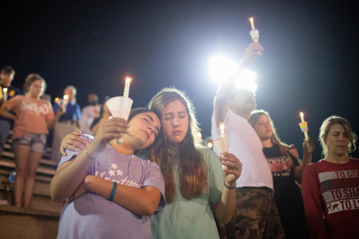 Lilly Yahya and Sarah White lean on each other during a vigil for Battle Creek Middle School sixth-grade student Kailee Grace Warren, 11, a victim of a shooting, at Spring Hill High School in Spring Hill, Tenn., on Wednesday, Oct. 13, 2021.