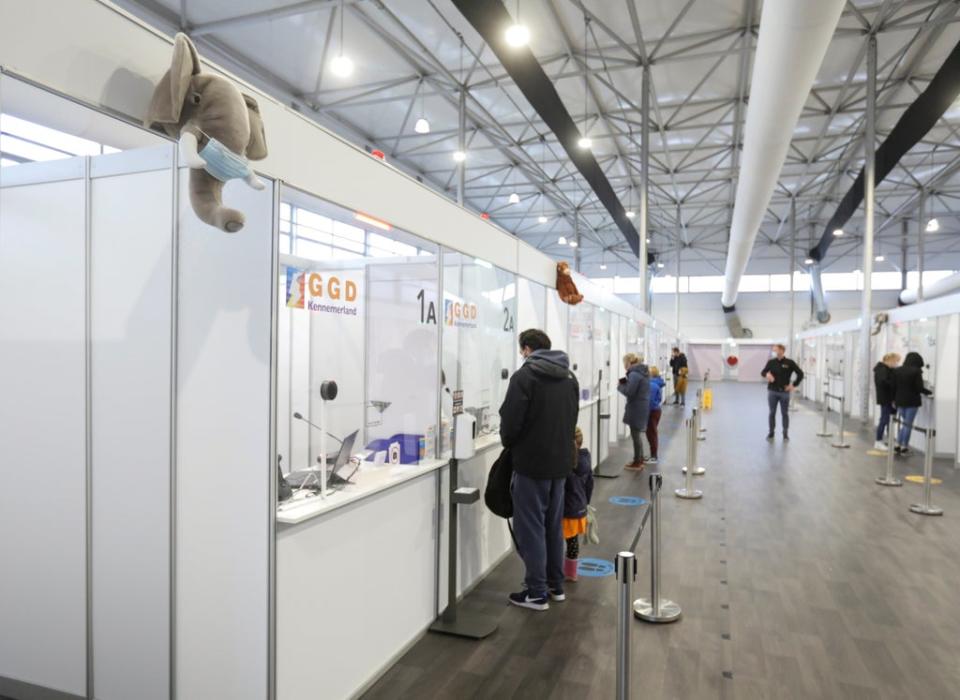 People stand at a counter at the XL Schiphol test location (REUTERS)