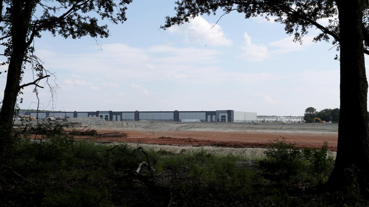 The warehouses at the Rockingham Farm Logistics Park can be seen through a thin tree line behind the home of a Buckhalter Road resident. Site prep is underway for another structure, which will be just yards away from their back porch.