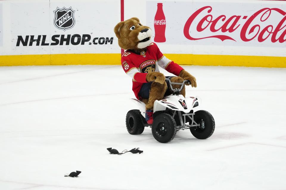 The Panthers' real mascot, Stanley C. Panther, rides an ATV on the ice after Florida defeated San Jose at Amerant Bank Arena last October.