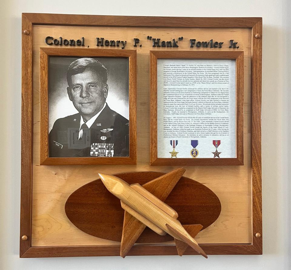 Photo display of Colonel Henry Fowler, USAF, Retired outside of the courtroom which is dedicated in his honor. Fowler’s service to the United States, reflected both his heroism in uniform and his continued selfless support to Maxwell, particularly its core of education and training mission.