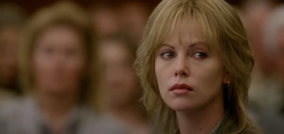 Charlize Theron as Josey Aimes with short, wavy hair and a serious expression, seen in a close-up shot in North Country.