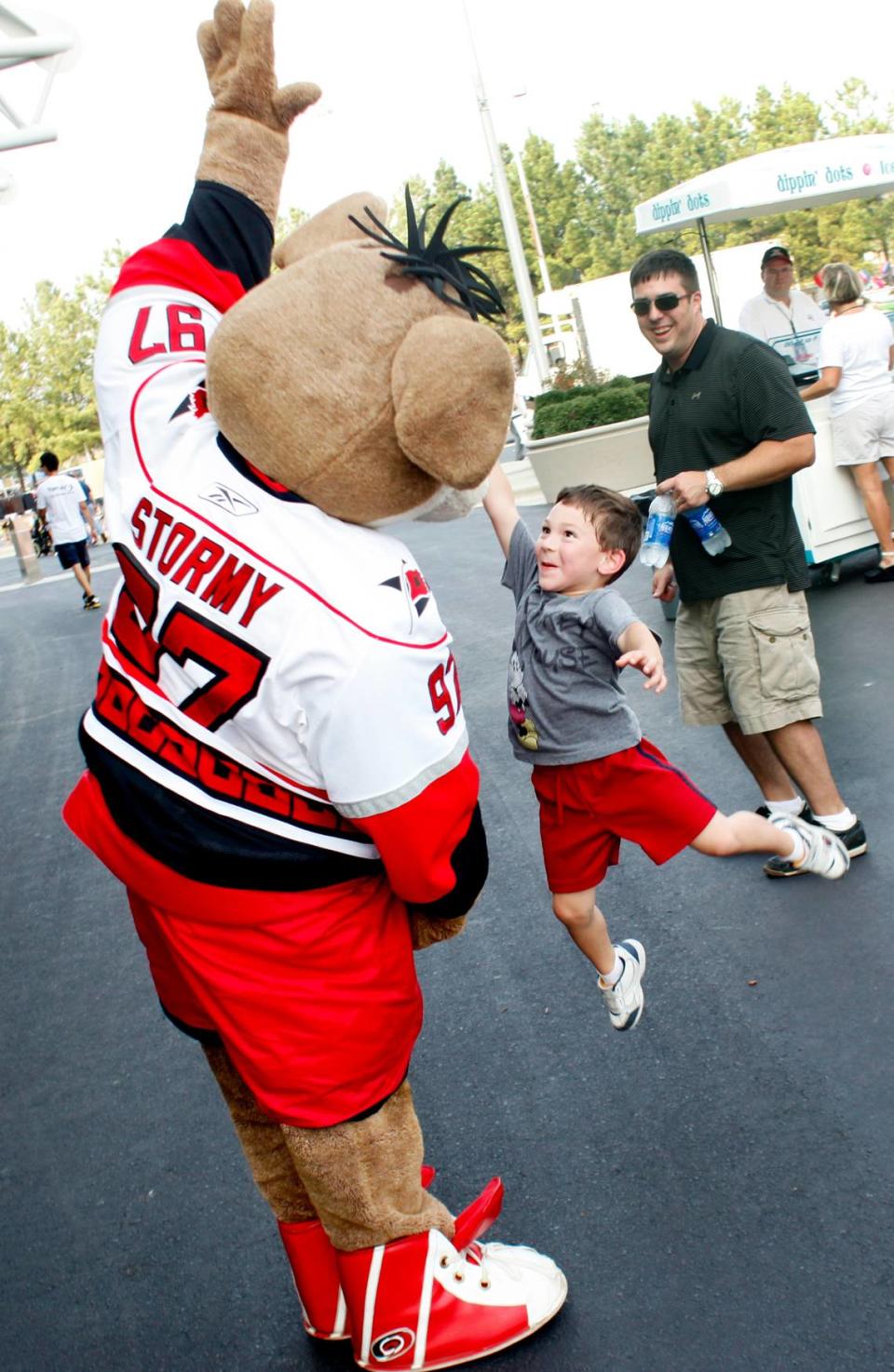 Four-year-old Christopher Zwirblia of Raleigh jumps to try to high five Stormy during the Carolina Hurricanes’ fourth annual Summer Fun Fest Friday, July 22, 2011 on the south lawn of the RBC Center.