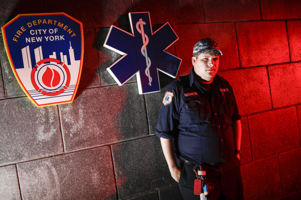 Paramedic Travis Kessel is photographed outside his station house after working a shift amid the COVID-19 pandemic, Monday, April 6, 2020, in the Bronx borough of New York. Kessel never imagined his work could hurt this much. He loves his career in emergency services. It's even how he met his wife, an emergency room nurse. But now he worries about the toll the new coronavirus is taking on both of them and their colleagues. (AP Photo/John Minchillo)