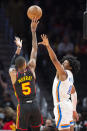 Atlanta Hawks guard Dejounte Murray shoots against Oklahoma City Thunder forward Jalen Williams during the first half of an NBA basketball game, Monday, Dec. 5, 2022, in Atlanta. (AP Photo/Hakim Wright Sr.)