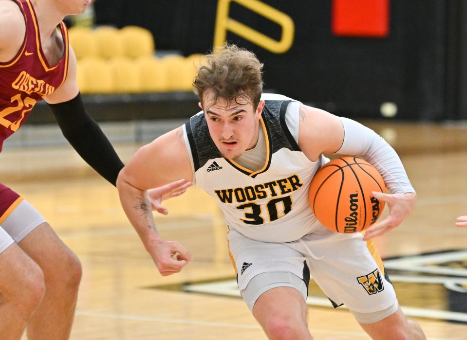 The College of Wooster's JJ Cline drives toward the basket.