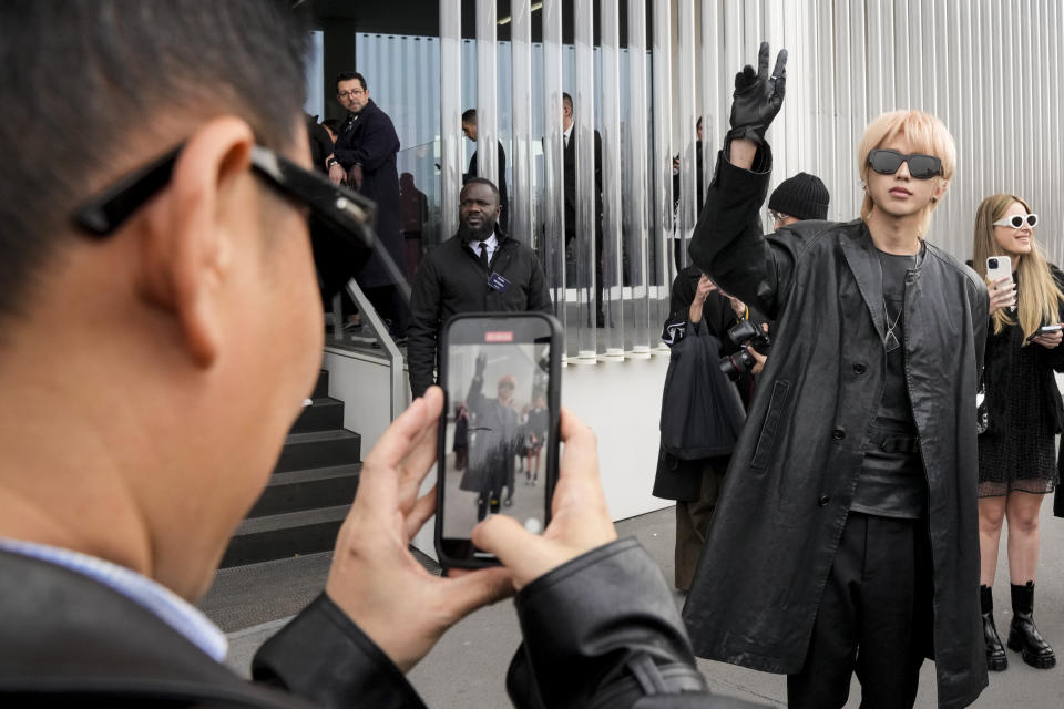 Kun poses for a photograph after leaving the Prada women's Fall-Winter 2023-24 collection presented in Milan, Italy, Thursday, Feb. 23, 2023. (AP Photo/Luca Bruno)