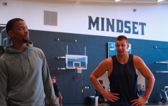 Providence College men's basketball coach Kim English, left, and former Patriots tight end Rob Gronkowski at the Ruane Friar Development Center on the PC campus.