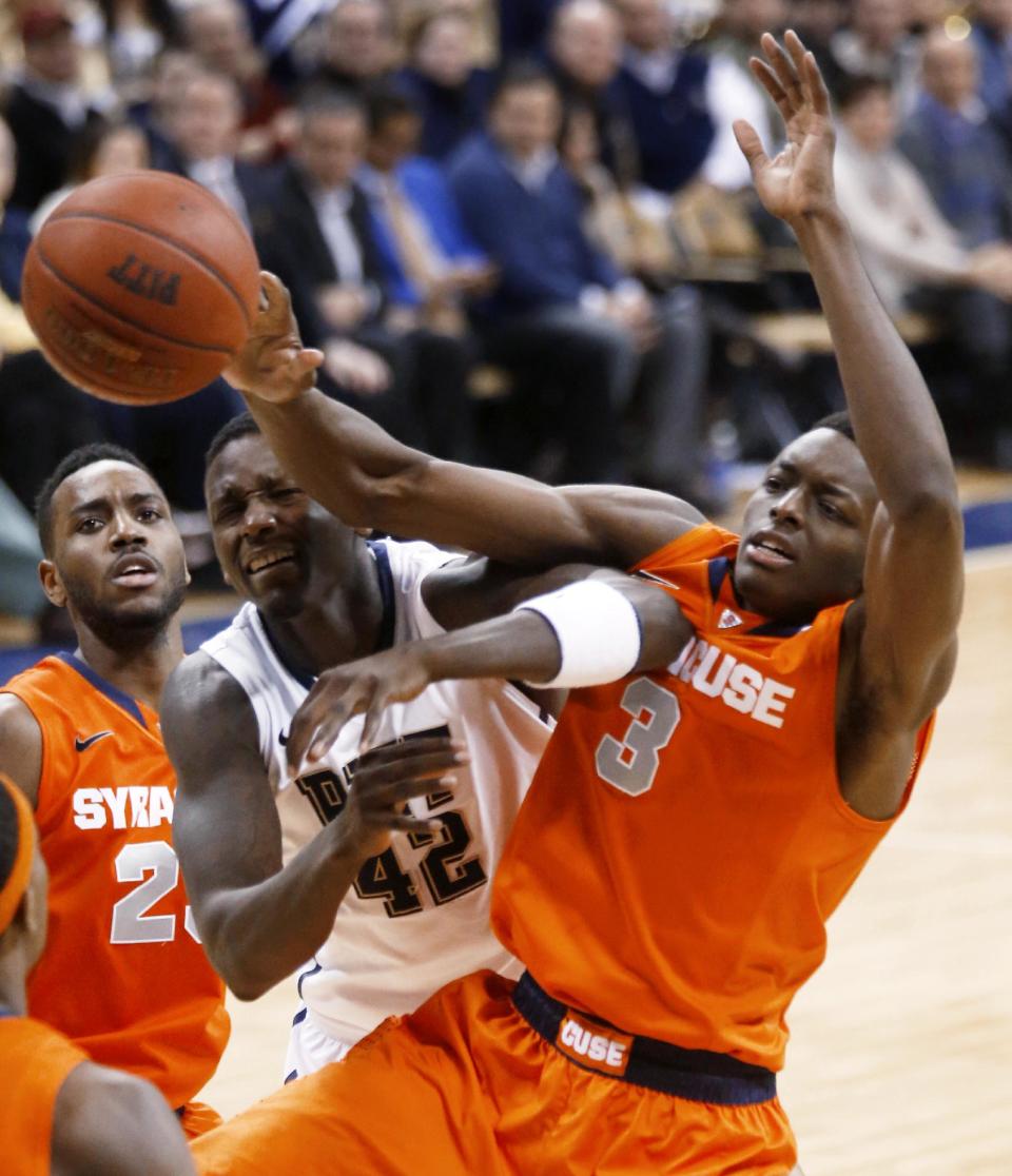 Pittsburgh's Talib Zanna (42) and Syracuse's Jerami Grant compete for a rebound during the second half of an NCAA college basketball game Wednesday, Feb. 12, 2014, in Pittsburgh. (AP Photo/Keith Srakocic)