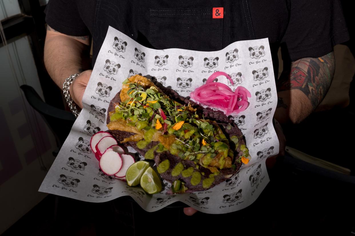 Chef Rulis holds a plate of chicken chicharron tacos that are prepared at the Asian-inspired Taqueria, Chin-Gon-Chow, on Thursday, June 20, 2024. The restaurant will open on Taco Tuesday, June 25, at 11360 Montwood Drive in East El Paso.