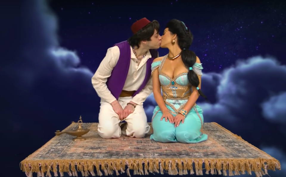 dressed as Jasmine and Aladdin, Pete and Kim kiss on the magic carpet in an SNL skit