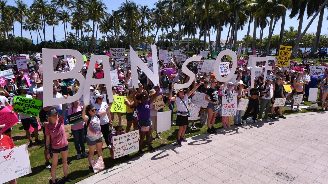 People attend an abortion-rights rally and march sponsored by the League of Women Voters held at the Meyer Amphitheater in downtown West Palm Beach on Saturday, May 14, 2022.