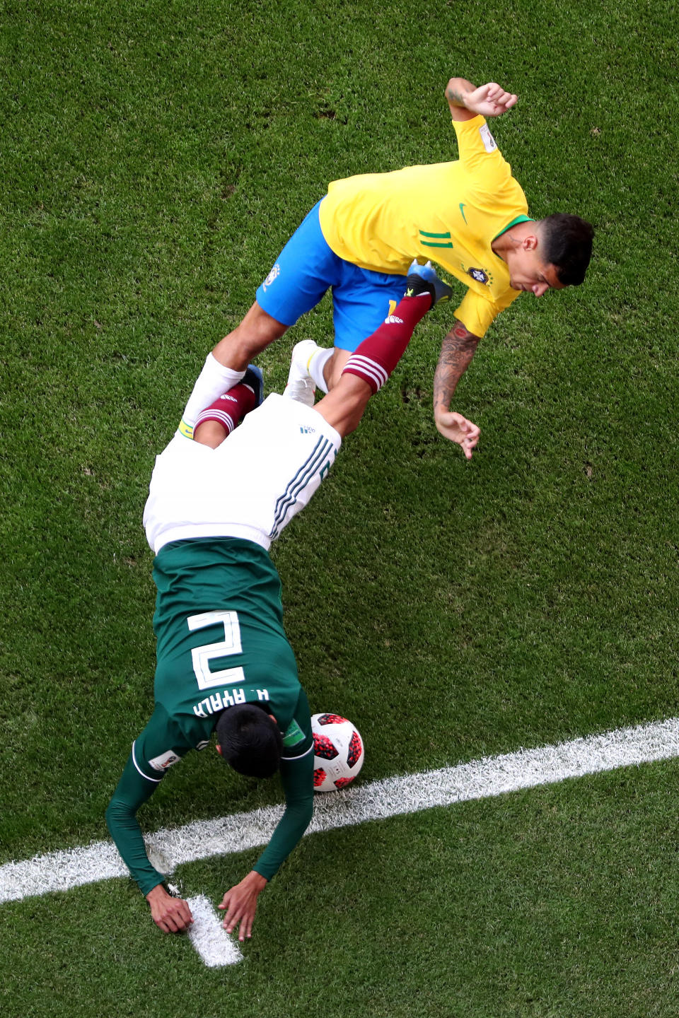 <p>Hugo Ayala of Mexico is challenged by Philippe Coutinho of Brazil during the 2018 FIFA World Cup Russia Round of 16 match between Brazil and Mexico at Samara Arena on July 2, 2018 in Samara, Russia. (Photo by Clive Rose/Getty Images) </p>