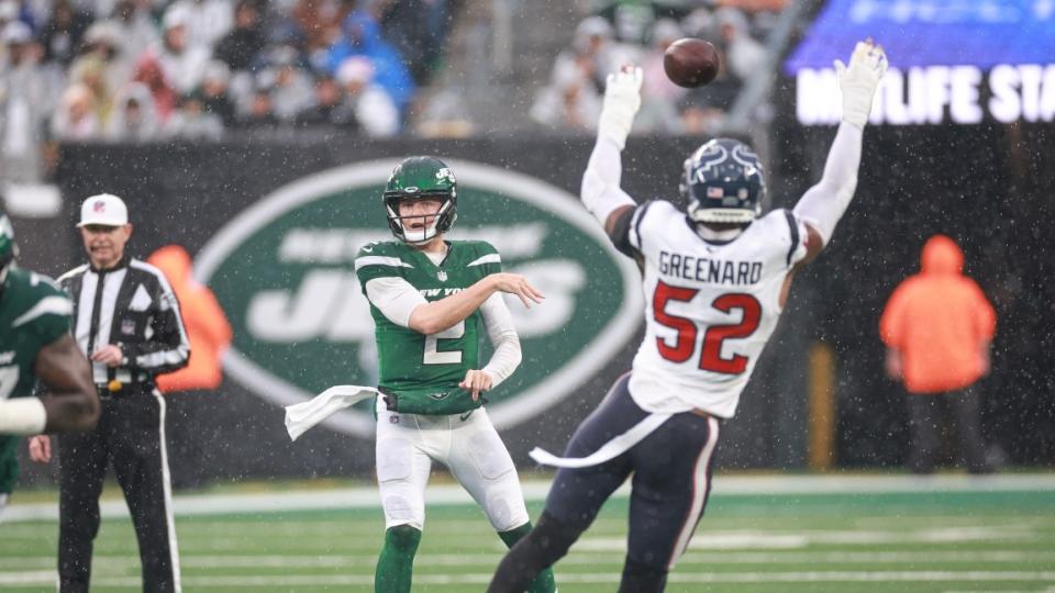 New York Jets quarterback Zach Wilson (2) throws the ball as Houston Texans defensive end Jonathan Greenard (52) defends during the first half at MetLife Stadium.