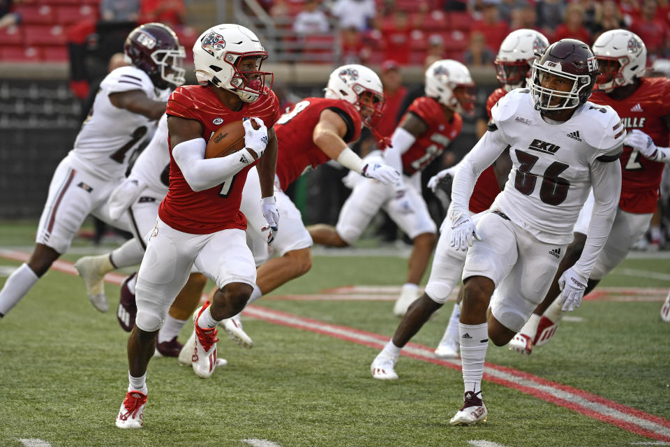 Louisville's Braden Smith (4) is pursued by Eastern Kentucky's Kyle Bailey (36) during the first half of an NCAA college football game in Louisville, Ky., Saturday, Sept. 11, 2021. (AP Photo/Timothy D. Easley)