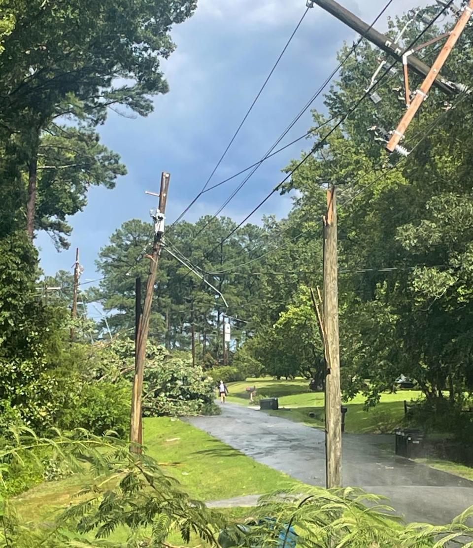 Power poles are snapped on Alpine Road in Durham, N.C., after a powerful storm blew through Tuesday, August 15, 2023.