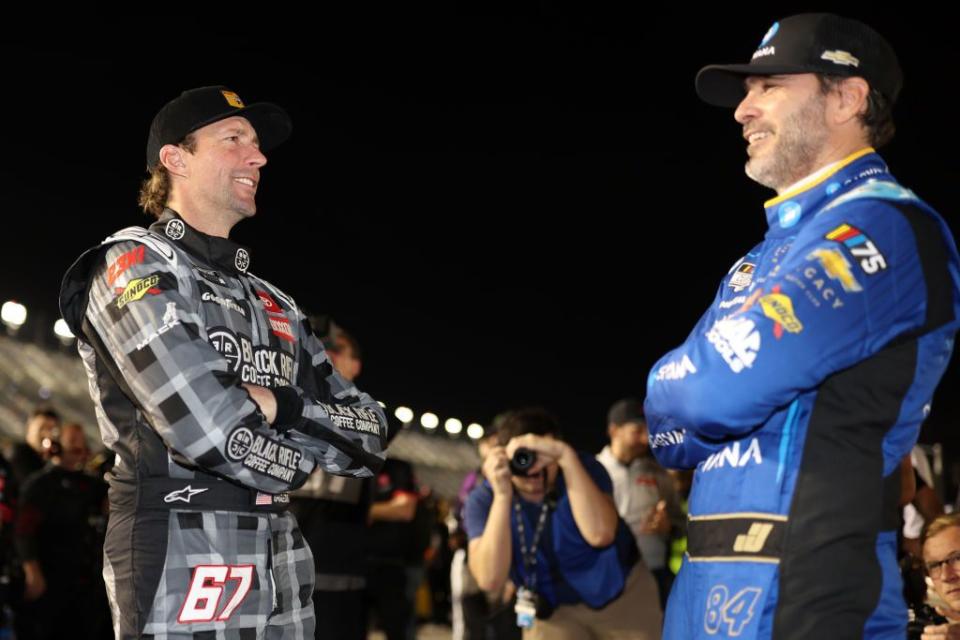 daytona beach, florida february 15 travis pastrana, driver of the 67 black rifle coffee toyota, l and jimmie johnson, driver of the 84 carvana chevrolet, talk on the grid during qualifying for the busch light pole at daytona international speedway on february 15, 2023 in daytona beach, florida photo by james gilbertgetty images