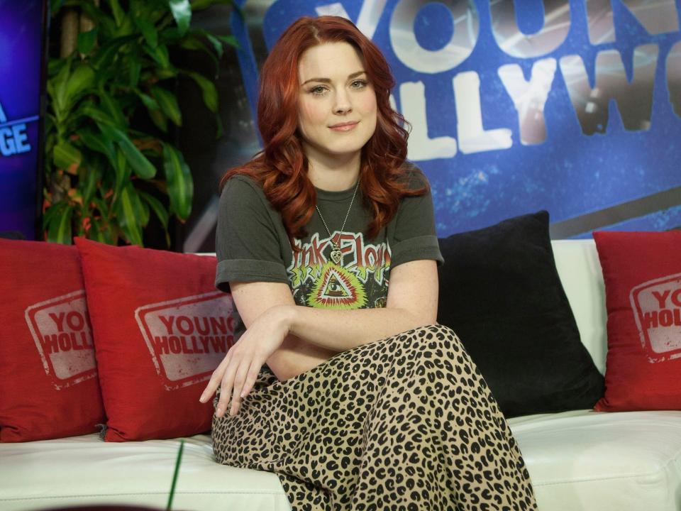 Alexandra Breckenridge in 2011 sitting on a couch