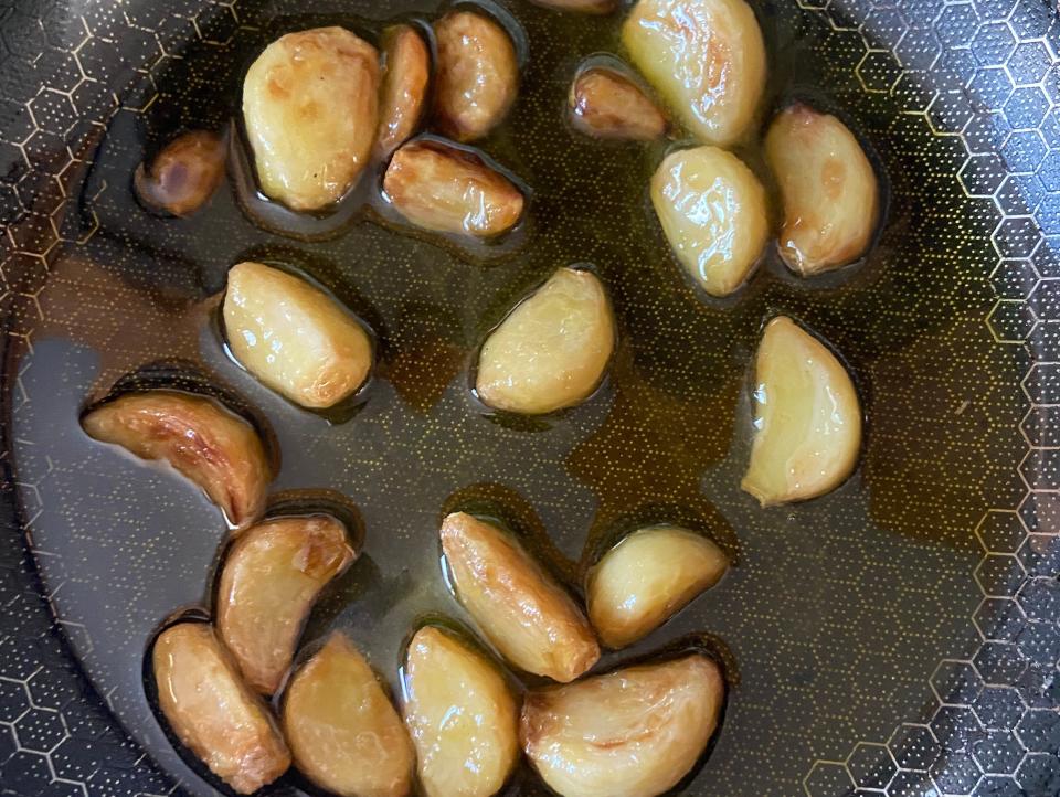 Garlic cooking in a pan with oil