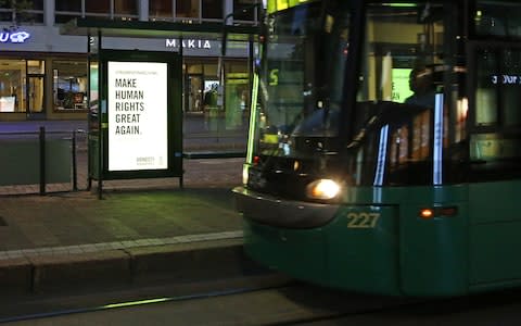 A billboard with a message to US President Donald Trump is seen in Helsinki - Credit: UPI / Barcroft