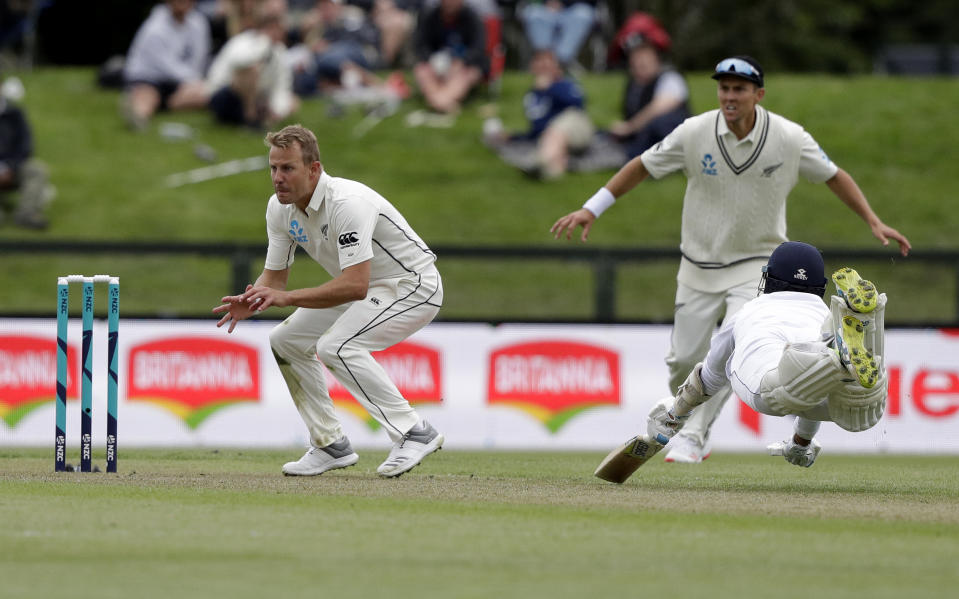 Sri Lanka's Roshen Silva, right, dives to make his ground as New Zealand's Neil Wagner waits for the ball during play on day one of the second cricket test between New Zealand and Sri Lanka at Hagley Oval in Christchurch, New Zealand, Wednesday, Dec. 26, 2018. (AP Photo/Mark Baker)