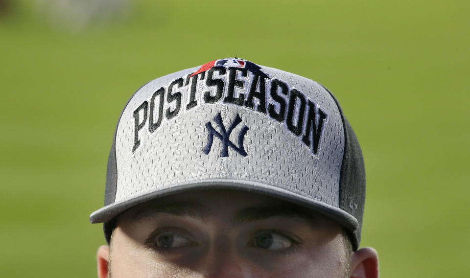 Matt Seelinger watches batting practice from the right field seats before the start of the American League wild card baseball game between the Houston Astros and the New York Yankees in New York, in this Tuesday, Oct. 6, 2015, file photo. Seelinger and several thousand other minor leaguers are finally getting back to work. After major league players depart their camps in Florida and Arizona to begin the big league season April 1, the lucky minor leaguers who kept their jobs through the past year will take their places in spring training, resuming careers put on pause by the pandemic. (AP Photo/Julie Jacobson, File)