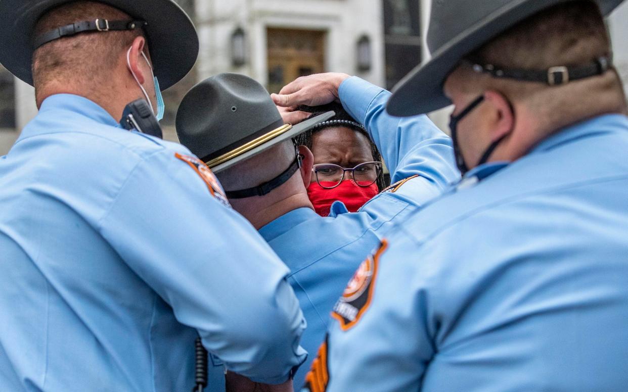 State Rep. Park Cannon, D-Atlanta, is placed into the back of a Georgia State Capitol patrol car after being arrested by Georgia State Troopers at the Georgia State Capitol Building in Atlanta, - Alyssa Pointer /AP