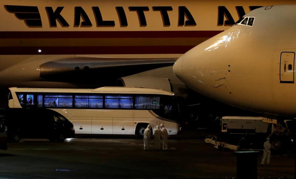 A bus believed to carry the US passengers of the cruise ship Diamond Princess as they board a flight home. (REUTERS)