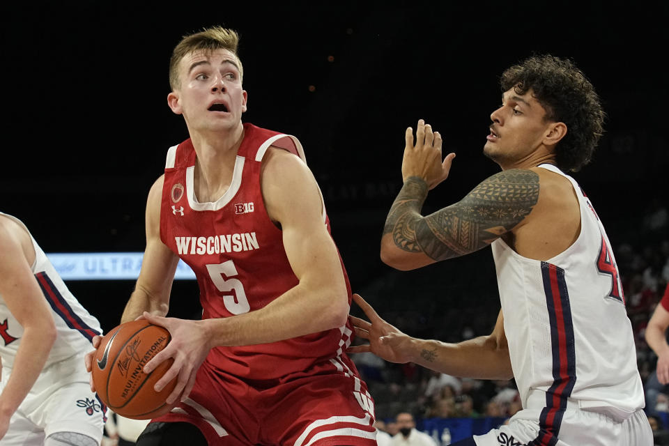 Wisconsin forward Tyler Wahl (5) looks to score on St. Mary's forward Dan Fotu in the first half during an NCAA college basketball game at the Maui Invitational in Las Vegas, Wednesday, Nov. 24, 2021. (AP Photo/Rick Scuteri)