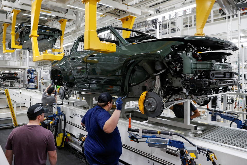 Employees works on an assembly line at startup Rivian Automotive's electric vehicle factory in Normal, Illinois, U.S. April 11, 2022. Picture taken April 11, 2022.  REUTERS/Kamil Krzaczynski