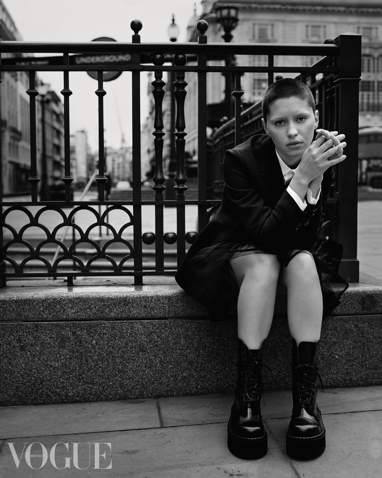 Iris Law looks at the camera while sitting down