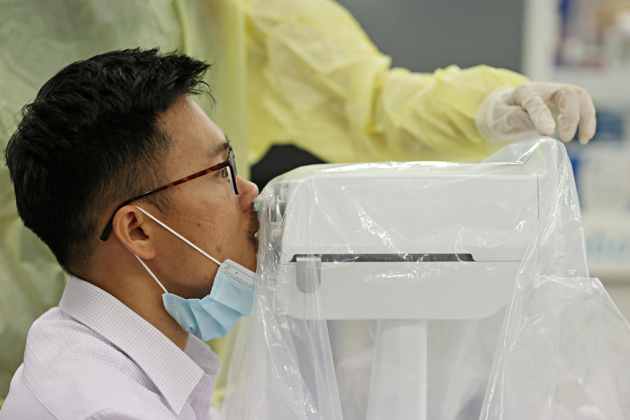 A coronavirus disease (COVID-19) swab test robot called SwabBot performs a self-administered nasal swab on a man during a demonstration in Singapore September 25, 2020.  REUTERS/Edgar Su