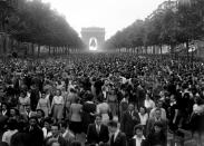 <p>Thousands gather on the Champs-Élysées avenue, in front of the Arc de Triomphe.</p>