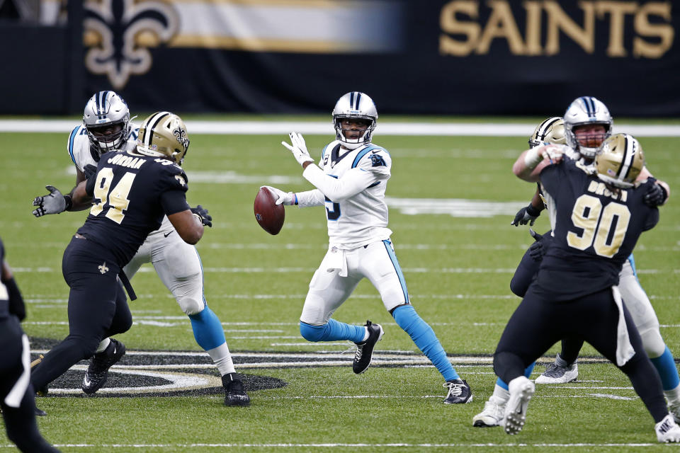 Carolina Panthers quarterback Teddy Bridgewater scrambles under pressure from New Orleans Saints defensive end Cameron Jordan (94) and defensive tackle Malcom Brown (90) in the second half of an NFL football game in New Orleans, Sunday, Oct. 25, 2020. (AP Photo/Butch Dill)