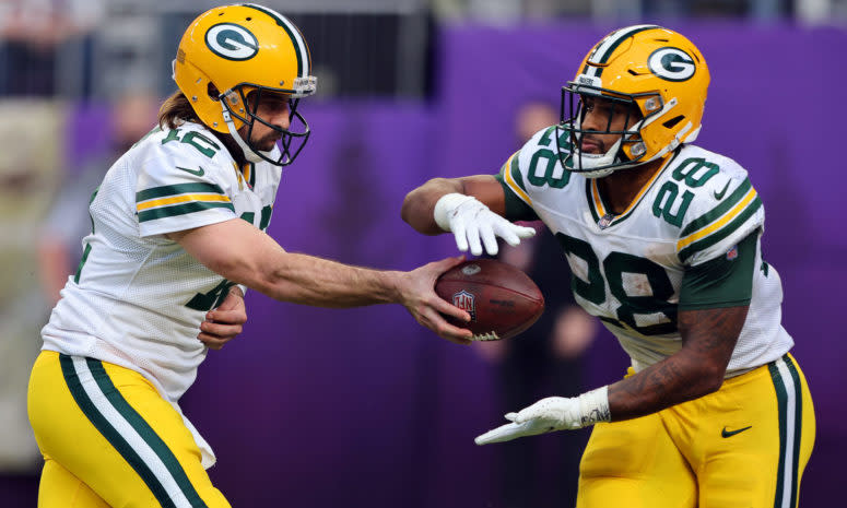 Aaron Rodgers hands off the ball to AJ Dillon.