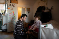 Adi, 37, who works for a removal company, prepares his daughter Elena, who is two years and seven-months old, for a trip to Hampstead Heath, at their home in London, Britain, February 3, 2019. REUTERS/Alecsandra Dragoi