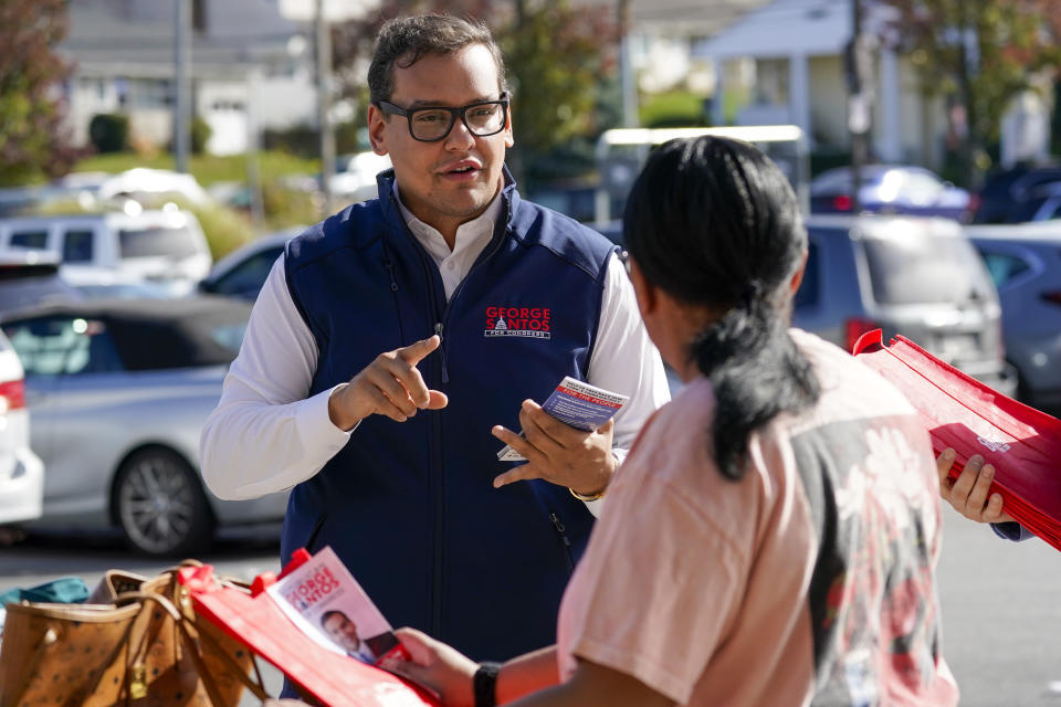 George Santos talks to a voter while campaigning 