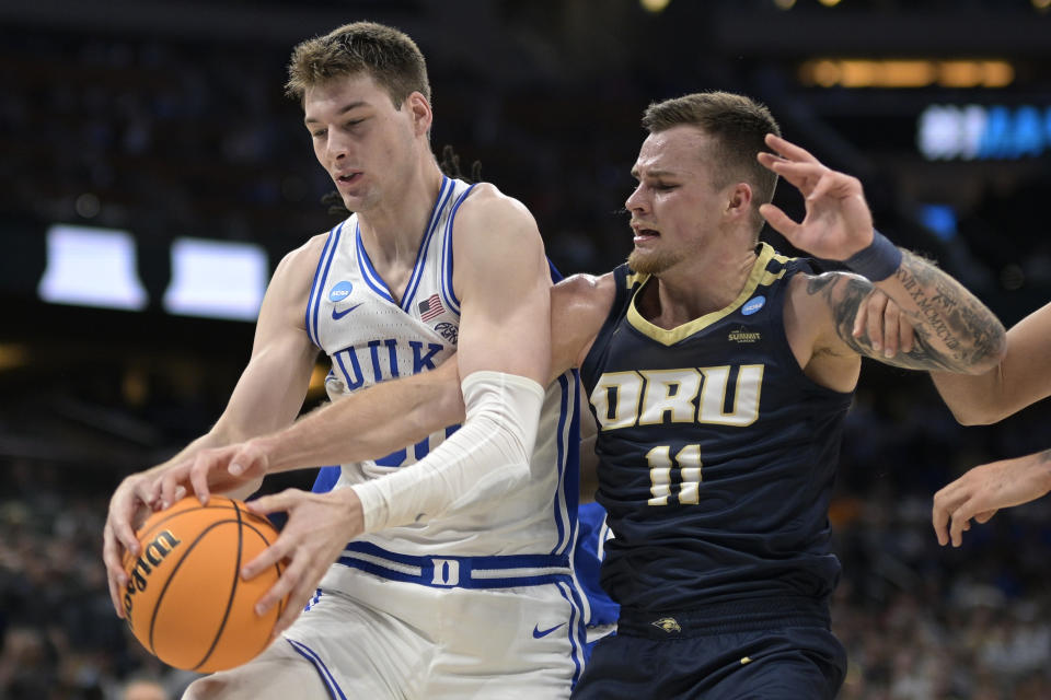 Duke center Kyle Filipowski, left, and Oral Roberts guard Carlos Jurgens (11) compete for a rebound during the first half of a first-round college basketball game in the NCAA Tournament, Thursday, March 16, 2023, in Orlando, Fla. (AP Photo/Phelan M. Ebenhack)