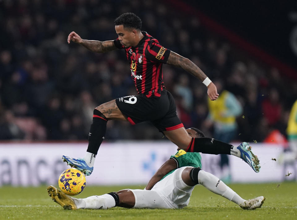 Bournemouth's Justin Kluivert, in air, is challenged by Newcastle United's Jamaal Lascelles, during the English Premier League soccer match between Bournemouth and Newcastle United, at the Vitality Stadium, in Bournemouth, England, Saturday, Nov. 11, 2023. (Andrew Matthews/PA via AP)