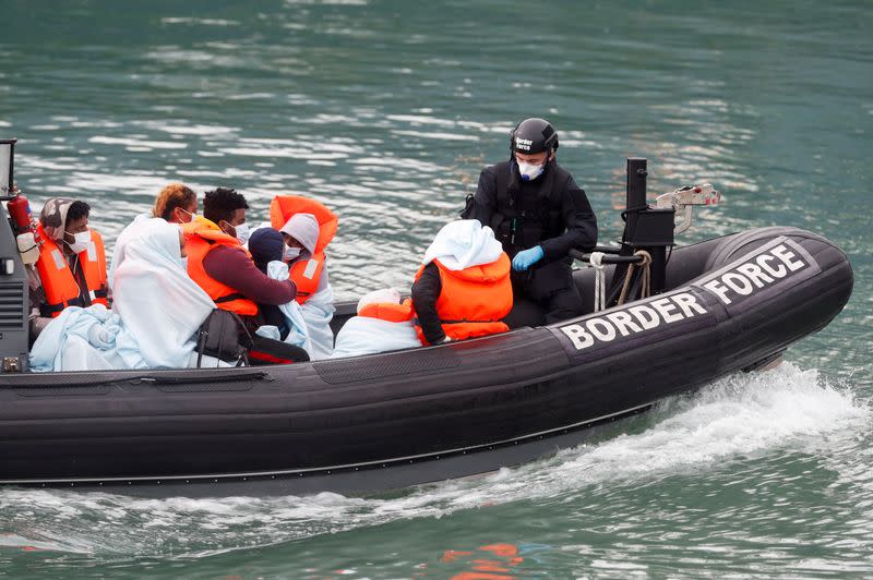 FILE PHOTO: Border Patrol agents bring migrants into Dover harbour on a boat, in Dover