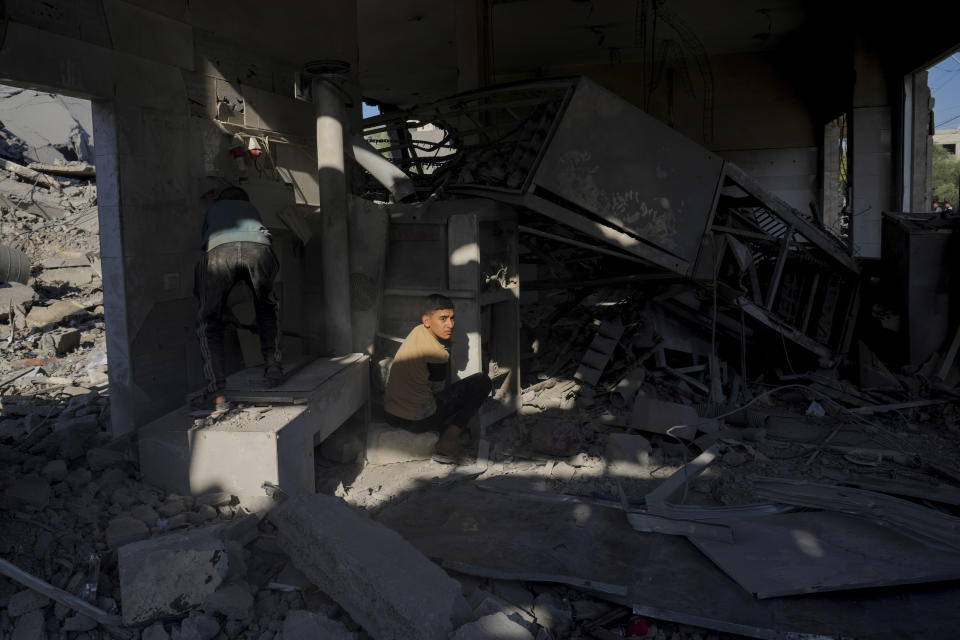 Palestinians inspect a house after it was hit by an Israeli airstrike in Deir al Balah, Gaza, on Monday, Dec. 4, 2023. (AP Photo/ Hatem Moussa)