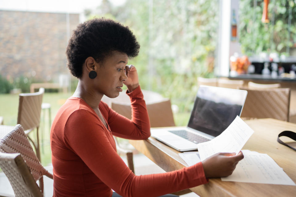 Worried mature woman doing home finances at home