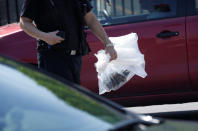 <p>A policeman carries a plastic bag after the blast outside the U.S. Embassy in Beijing, China, July 26, 2018. (Photo: Jason Lee/Reuters) </p>